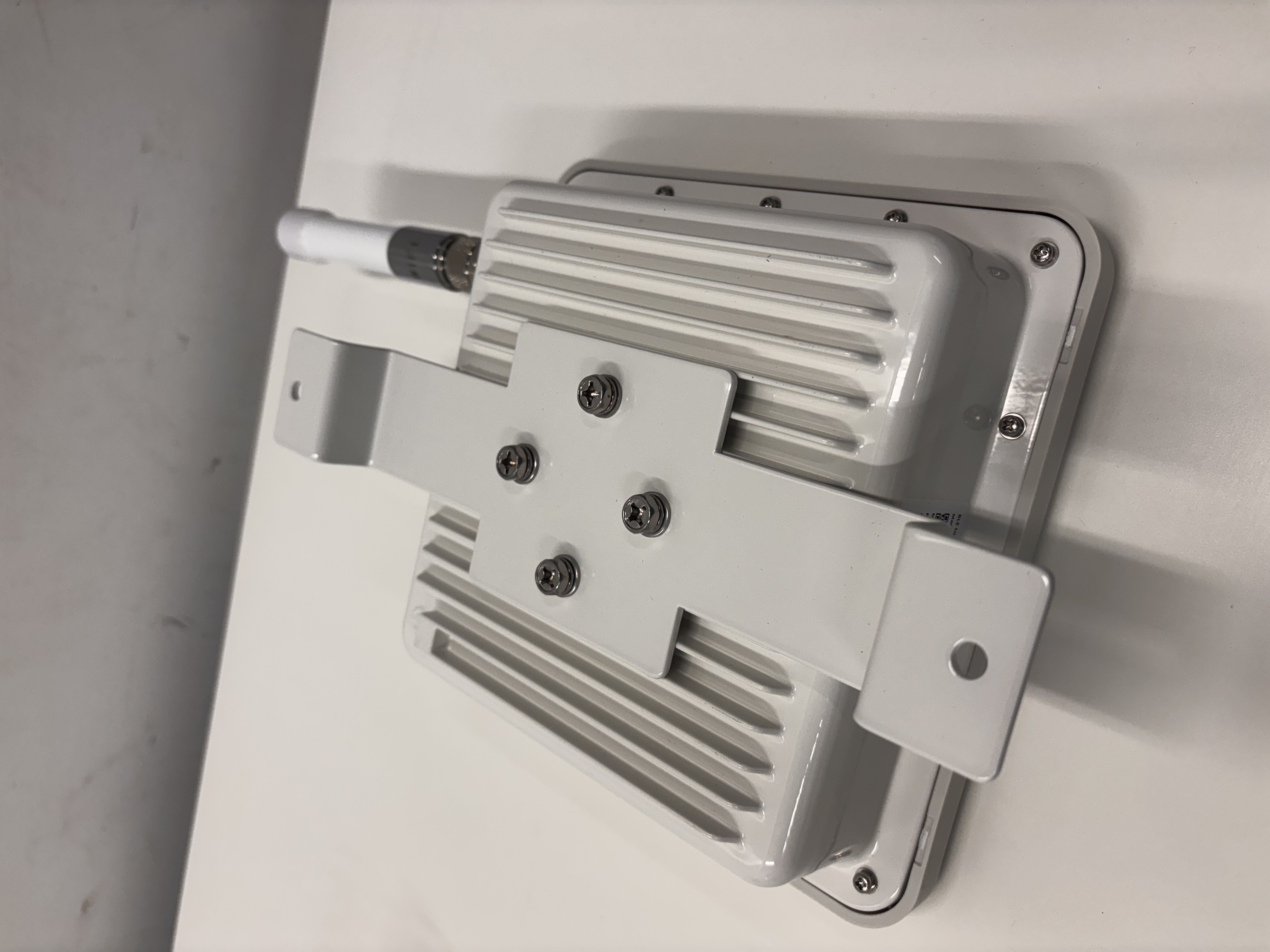 Outdoor Gateway with the pole-mount kit attached to the back of the housing, ready to band onto a pole