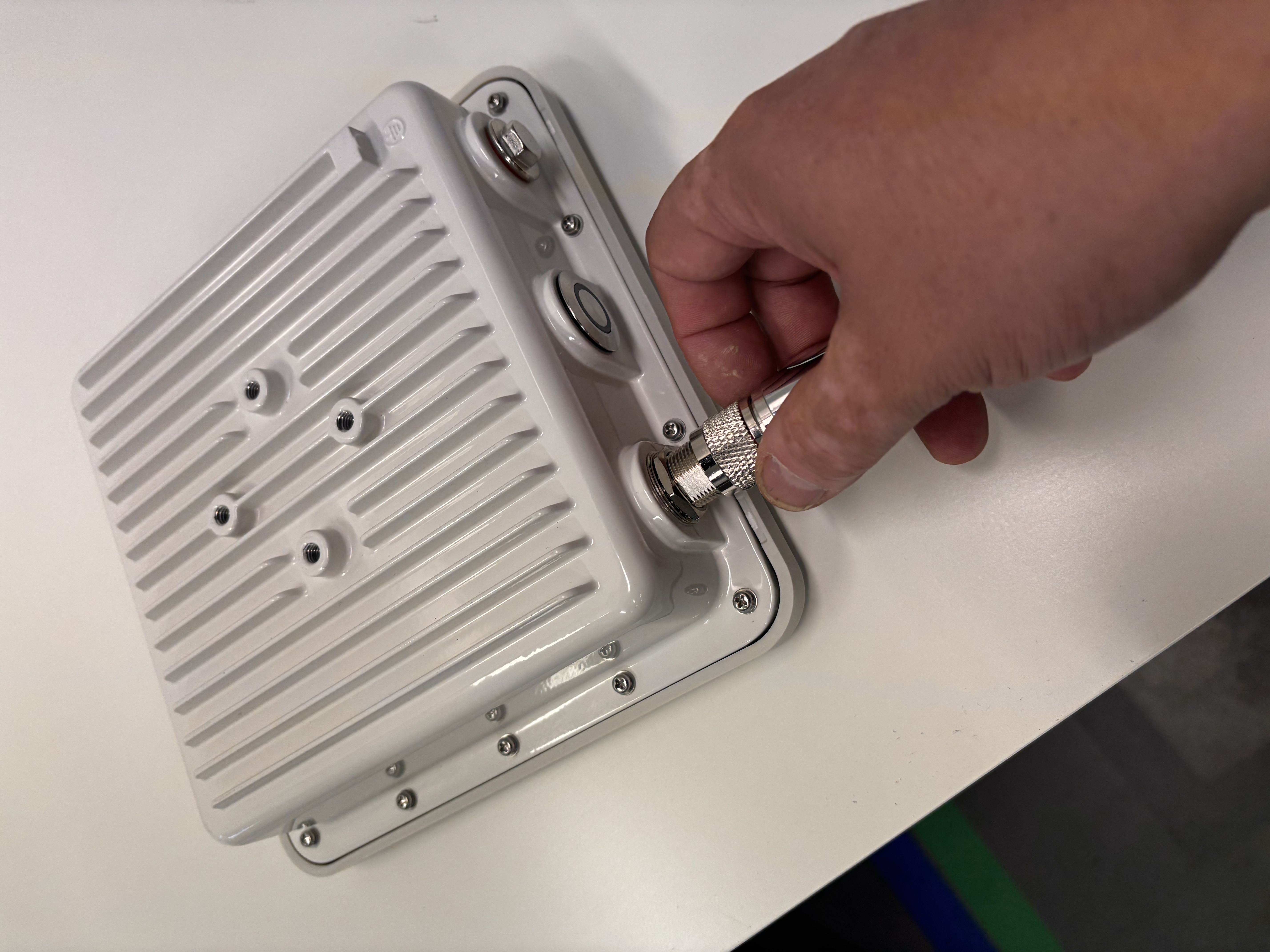 Threading the antenna onto the Outdoor Gateway bottom connector