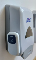 Universal Dispenser Beacon installed on a Gojo FMX-12 dispenser, seen from the front
